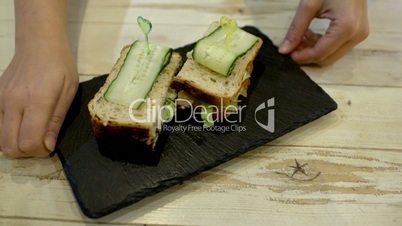 Serving a portion of sandwiches in cafe
