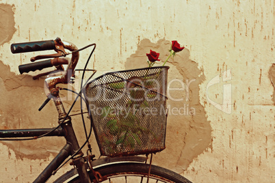 Digital painting of red roses in an old bicycle basket
