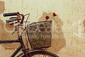 Digital painting of red roses in an old bicycle basket