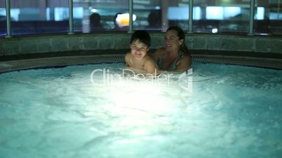 mother and son in hot tub