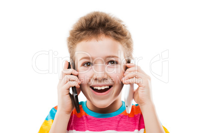 Smiling child boy talking two mobile phones or smartphones