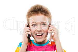 Smiling child boy talking two mobile phones or smartphones