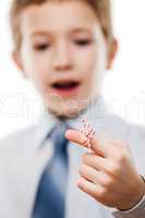 Child boy looking at finger tied string knot memory reminder