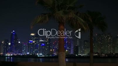 view of palm and Dubai skyscraper at night