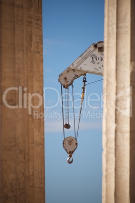 Crane appearing between two marble Parthenon columns