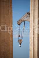 Crane appearing between two marble Parthenon columns