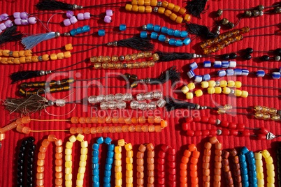 Necklaces of plastic beads on red cloth