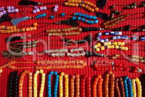 Necklaces of plastic beads on red cloth