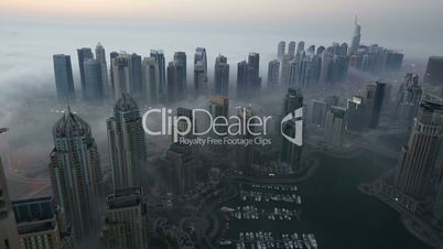 time lapse aerial view skyscraper foggy weather Dubai Marina at morning