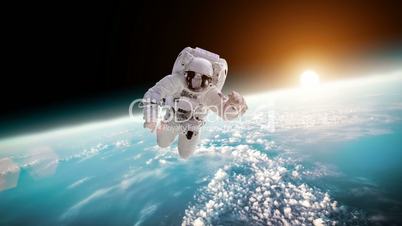 Astronaut in outer space against the backdrop of the planet earth. Elements of this image furnished by NASA.