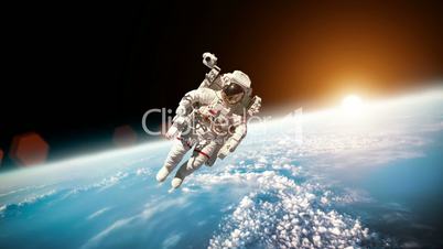 Astronaut in outer space against the backdrop of the planet earth. Elements of this image furnished by NASA.