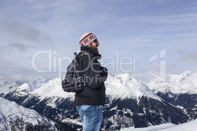 Young man enjoys the view in the mountains