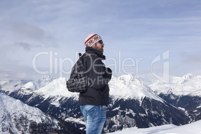 Young man enjoys the view in the mountains