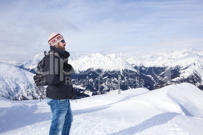 Young man enjoys the view in the mountains