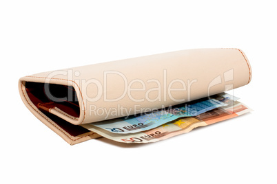 Monetary denominations lie in a wallet on a white background