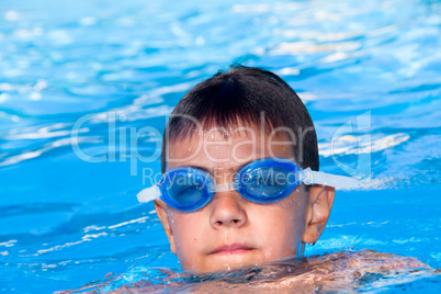 The boy floats in pool