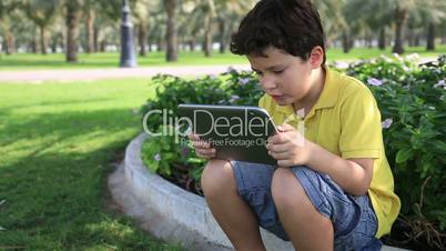 Young boy gaming on tablet computer