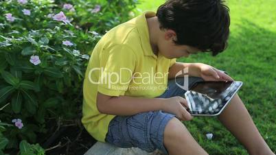 Young boy gaming on tablet computer