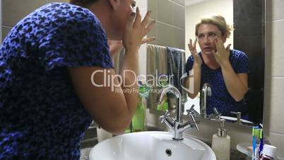 Woman Is Putting Cosmetic Cream On Her Face