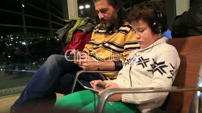 Father and son waiting at the airport