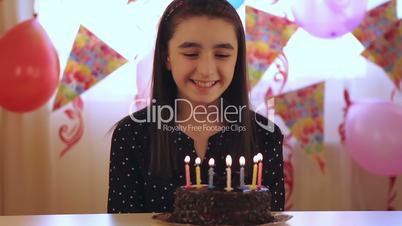 Young girl enjoying birthday cake