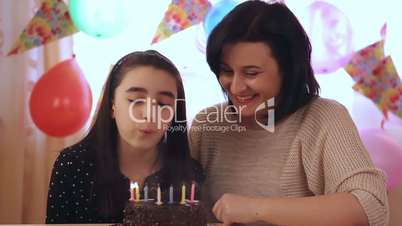 Mother and daughter with birthday cake