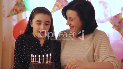 Mother and daughter with birthday cake