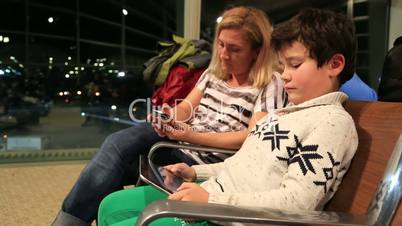 Mother and her little boy waiting at the airport