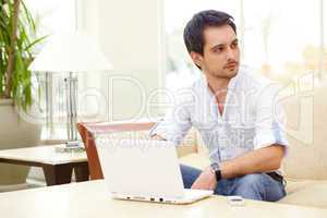 Young man sits with laptop