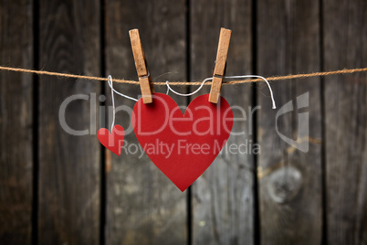Two Paper Hearts Hang on Clothesline