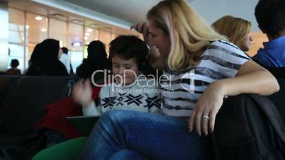 Mother and her little boy waiting at the airport