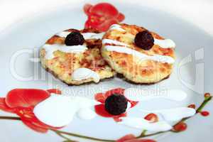 cheese cakes on the plate with raspberry