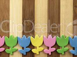 Colorful cut tulips on a chopping board.