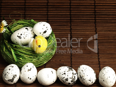 Easter chicken and eggs in the nest.