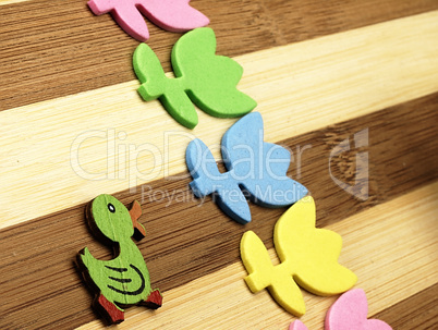 Colorful cut tulips and duck on a chopping board.