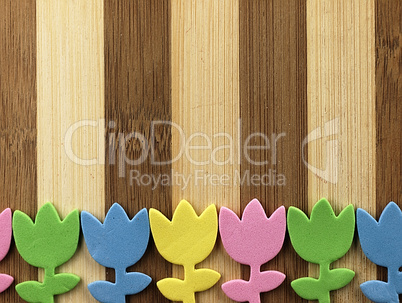 Colorful cut tulips on a chopping board.