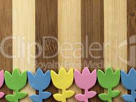 Colorful cut tulips on a chopping board.