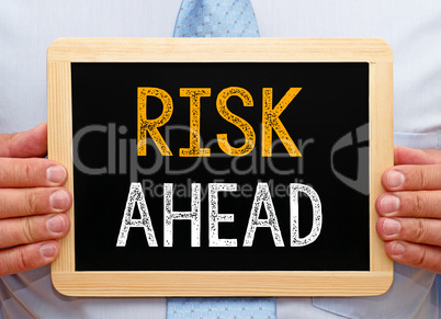 Risk ahead - Businessman with chalkboard