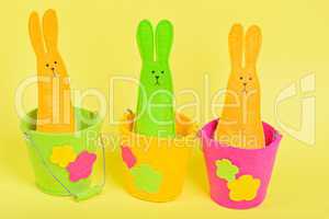 Three easter Bunnys in buckets on yellow