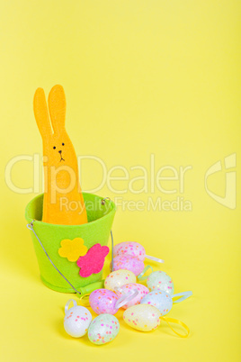 Easter Bunny in bucket on yellow