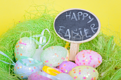 Ester eggs in nest with small chalkboard