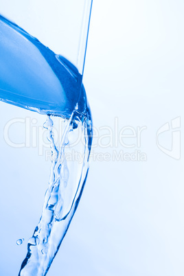 Cool Water Pouring from a Transparent Glass Cup