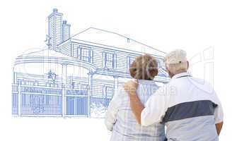 Embracing Senior Couple Looking At House Drawing on White