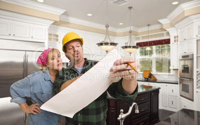 Contractor Discussing Plans with Woman Inside Custom Kitchen Int