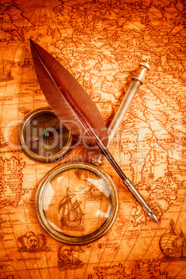 Vintage magnifying glass lies on an ancient world map