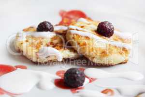 cheese cakes on the plate with raspberry