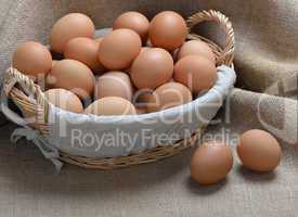 chicken eggs in a basket on sackcloth