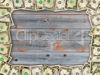 Frame from the dollars on the wooden board background