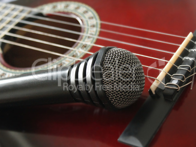 microphone laying on the guitar