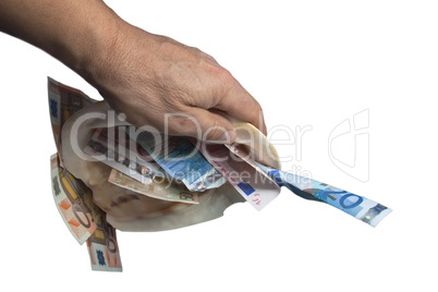 a hand is holding a sea shell with money white background.